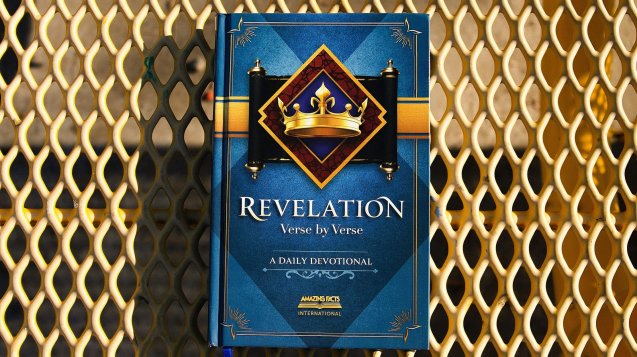 a blue book sitting on top of a metal grate